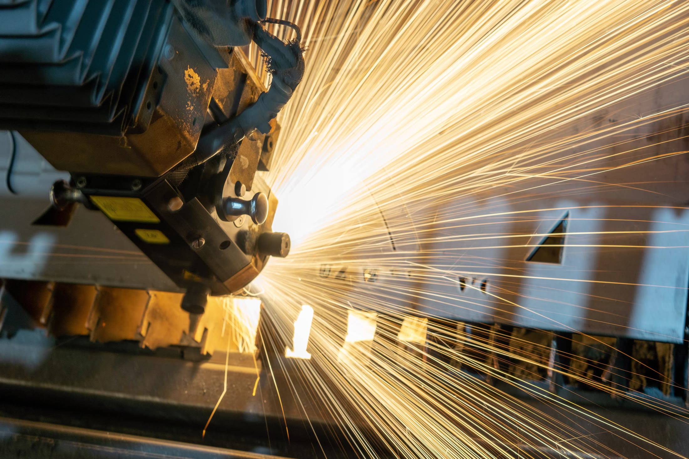 Industrial metal processing with visible sparks